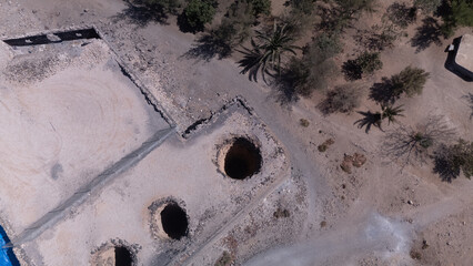 Ancient Water Wells and Ruins in Desert Landscape &ndash; Aerial View of Historical Site