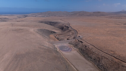 Aerial View of Desert Reservoir and Dam Structure in Arid Mountainous Landscape