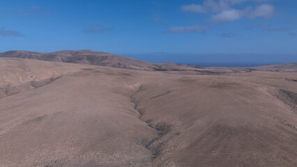 Desert Track Through Volcanic Hills Under Clear Sky – Remote Arid Landscape