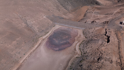 Aerial View of Desert Reservoir and Dam Structure in Arid Mountainous Landscape