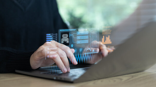 Businesswoman typing on laptop with hologram AI chatbot, virtual assistant, customer service icons, data analytics dashboard, modern business communication technology concept.