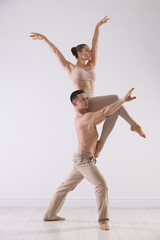 Couple of professional dancers training in studio