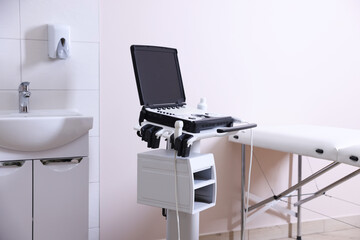 Modern ultrasound machine, sink and examination bed in clinic