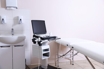 Modern ultrasound machine, sink and examination bed in clinic