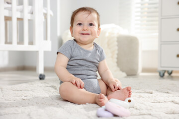 Fototapeta premium Cute little baby playing with toys in room