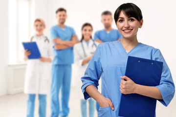 Medical assistant and other healthcare workers in hospital, selective focus