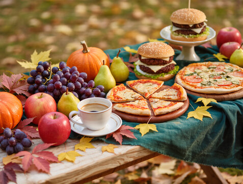 Autumn feast with savory burgers, delicious pizza, and fresh fruits