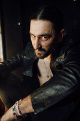 portrait of a handsome man with dark hair and a black beard