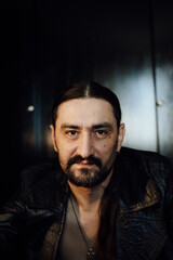 Fototapeta premium portrait of a handsome man with dark hair and a black beard