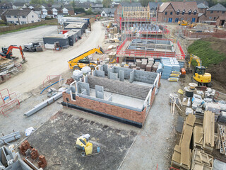 Unique, aerial view of a newly started construction of starter homes within a housing project in...