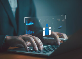 Businessman using laptop with digital customer analytics dashboard, symbolizing data-driven marketing, customer relationship management, business strategy, and audience targeting for corporate growth.