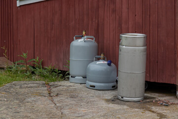 Gas cylinders and a keg stored together, showing industrial and beverage equipment, safe handling, and proper storage for liquids and gases in commercial or industrial settings