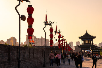 Old wall in Xian, China with traditional towers and red lanterns