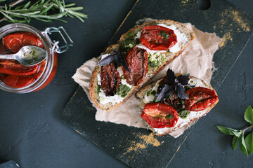 Toasted bread with pesto, creamy spread and sun dried tomatoes