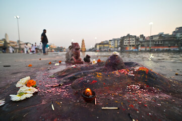 Fire burning in front of a small Shiva Lingaa as a part of Hindu rituals on the Ghats of River Godavari, Nasik, Maharashtra, India.