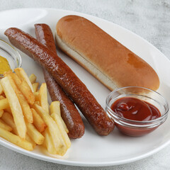 Classic fast food plate with grilled sausages french fries and sauces