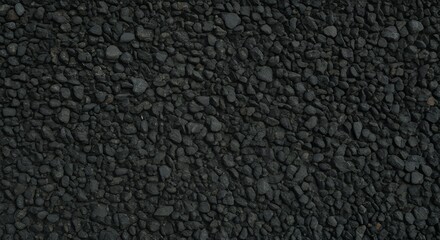 Fototapeta premium Close-up texture of black gravel stones, dark crushed rock surface background, perfect for construction, architecture, flooring, and natural abstract design concepts