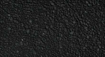 Fototapeta premium Close-up texture of black gravel stones, dark crushed rock surface background, perfect for construction, architecture, flooring, and natural abstract design concepts