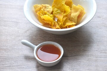 crispy fried dumpling paste stuffed chop pork and shrimp dipping sweet chili sauce on bowl