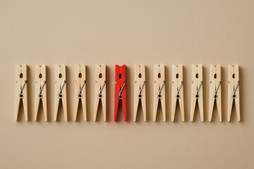 Differentiation Concept — One Red Clothespin Among Wooden Clothespins, Minimal Studio