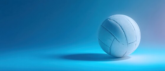 The volleyball on a smooth blue background showcasing elegance and simplicity.
