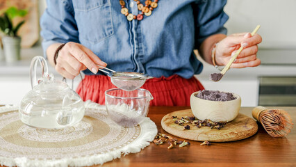 Woman Making Blue Matcha Tea And Sifting It Through A Strainer