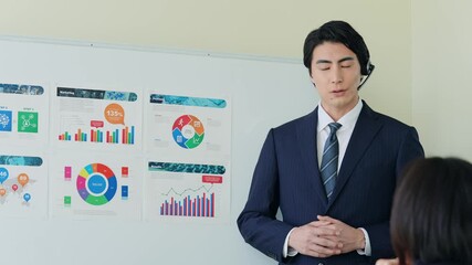 Male business person giving a lecture at a seminar