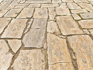 Ground view of textured stone pathway with ample space for text in a natural setting during daylight