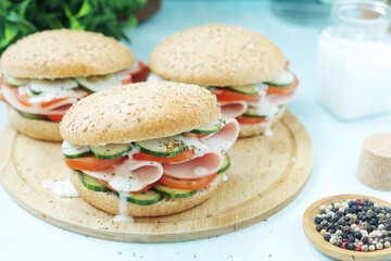 Bun sandwiches with salami and vegetables