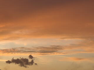 Vibrant sunset displaying a beautiful blend of orange, pink, and purple hues over a tranquil landscape at dusk