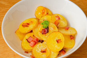 Baked sliced potatoes in bowl