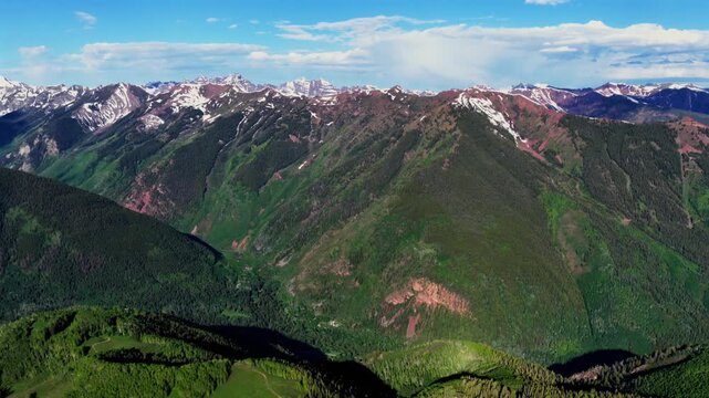 Aspen Mountain Ajax Little Annie Trailhead aerial drone Colorado Conundrum creek trail Castle Peak 14er Rocky Mountains Elk Range Aspen Trees spring summer morning blue sky clouds pan left motion