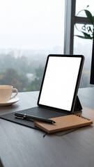 Fototapeta premium Creative Office: A stylish desk combining digital and traditional work elements, with a tablet screen suitable for adding blank text or a logo.