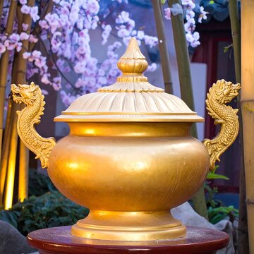 Golden ornate container in garden setting