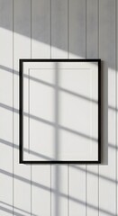 Minimalist Black Framed Mockup Sunlight Shadows on White Paneling.