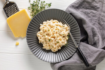American simple dish mac and cheese. Pasta with cheese and cream sauce in a plate on the table. Top view