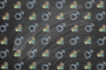 Vibrant chalk drawings display rainbow hearts and male gender symbols in a harmonious arrangement on a blackboard. The artwork promotes inclusivity