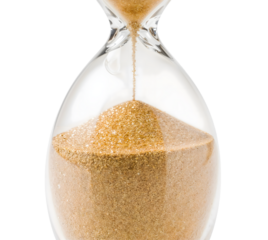 Closeup of classic glass hourglass with flowing golden sand isolated on the transparent background symbolizing time and patience