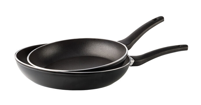 Two empty black frying pans with non-stick coating on transparent background
