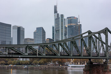 Frankfurt skyline with various skyscrapers behind the Iron Pedestrian Bridge (German: Eiserner Steg)