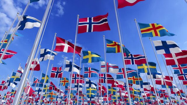 Scandinavian countries flags waving on metal poles against blue sky. Nordic states Denmark, Finland, Iceland, Norway and Sweden, the autonomous territories Faroe Islands and Greenland.