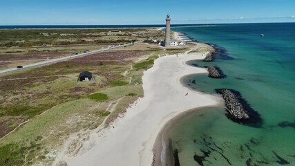 Skagen Denkmark Lighthouse on sunny day aerial footage