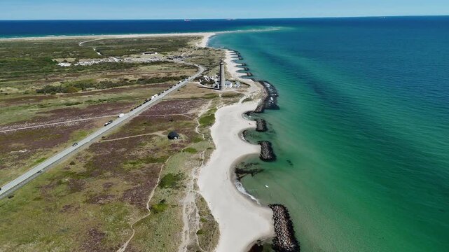 Skagen Denkmark Lighthouse on sunny day aerial footage