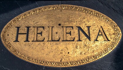 Ornate gold plaque with name