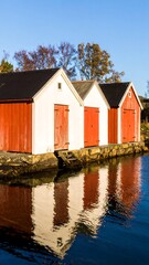 Colorful waterfront cabins reflected in water