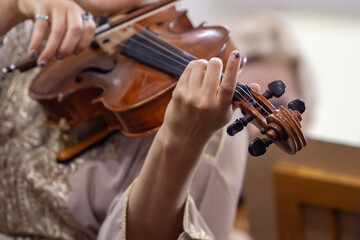 Close-up of a woman's hands playing the viola