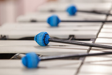 Close-up of drumsticks lying on a vibraphone