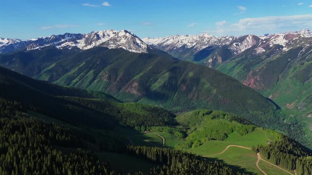 Conundrum creek trail Aspen Mountain Ajax Little Annie Trail 4wd road aerial drone Colorado Castle Peak 14er Rocky Mountains Elk Range Aspen Trees spring summer morning blue sky clouds forward pan up