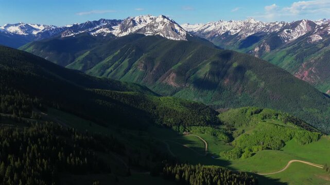 Aspen Mountain Ajax Little Annie Trailhead aerial drone Colorado Conundrum creek trail Castle Peak 14er Rocky Mountains Elk Range Aspen Trees spring summer morning blue sky clouds backwards pan up