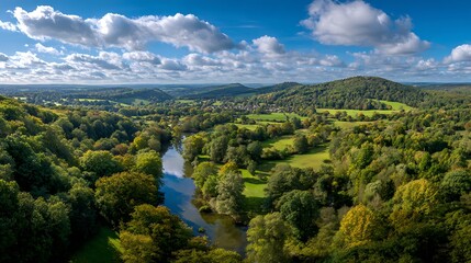 Obraz premium Aerial View of Lush Valley with River and Blue Cloudy Sky
